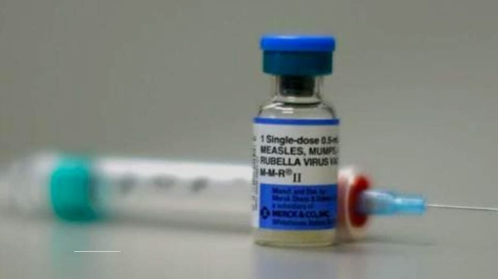 Close-up of a Measles, Mumps, Rubella (MMR) vaccine vial and syringe, emphasizing vaccination.