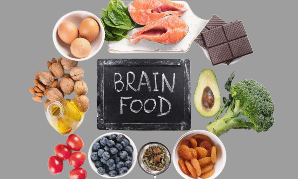 A table with berries, fish, greens, and walnuts for brain health.