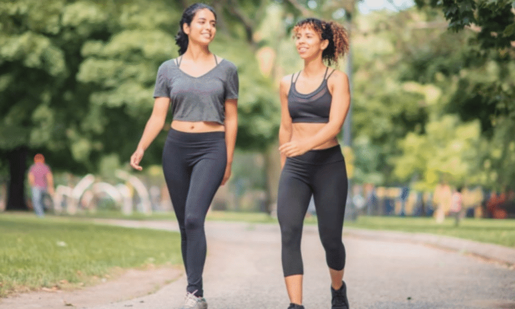 A person walking outdoors to improve heart health and cholesterol.