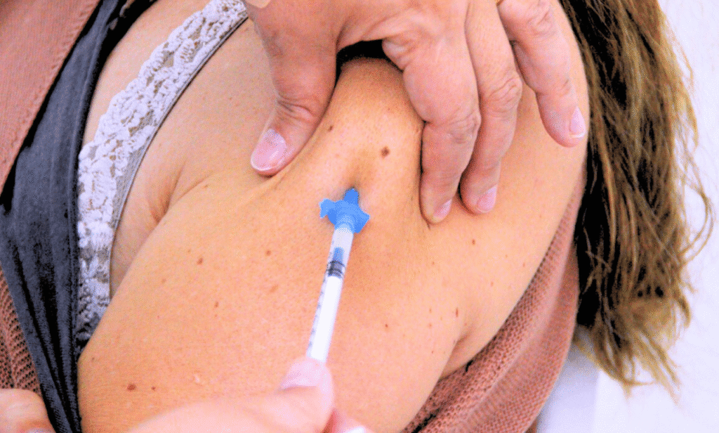 A doctor administering a flu vaccine to a patient.